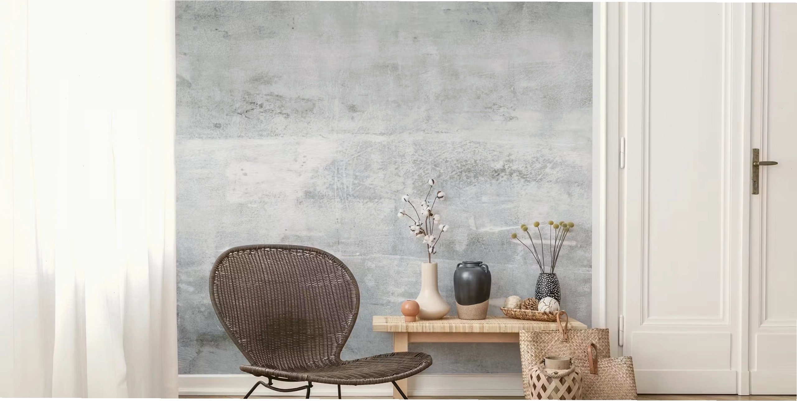 Light grey concrete look wallpaper in a room corner